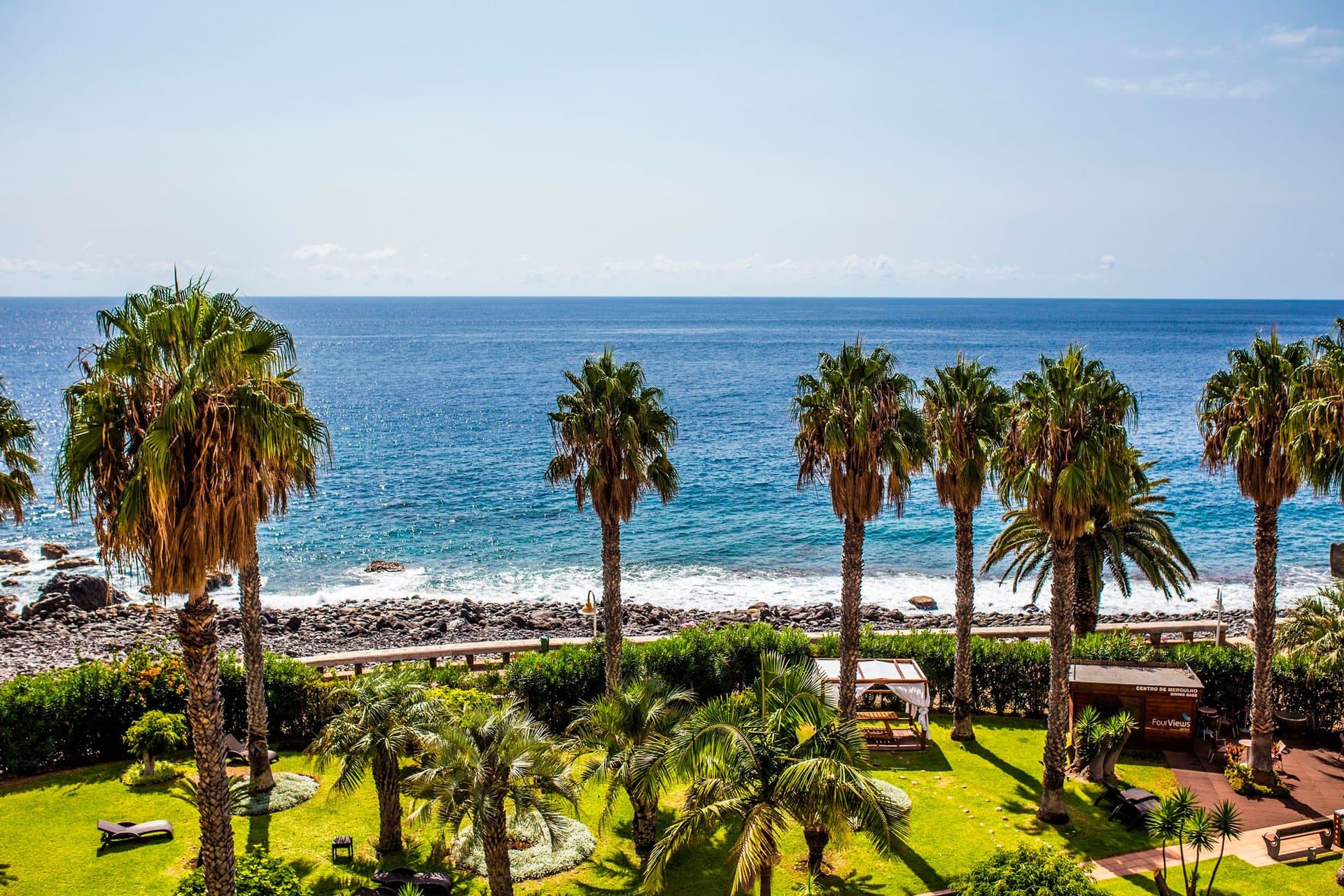 Oasis Caniço (The Views Oásis) — palm garden and ocean promenade — official photo, https://www.theviewshotels.pt/en/oasis/